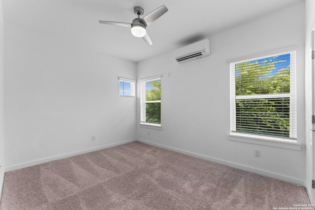 carpeted spare room with ceiling fan and a wall mounted AC