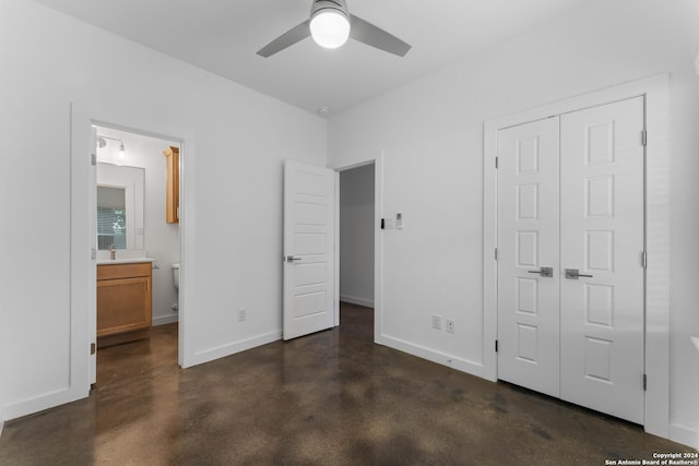 unfurnished bedroom featuring ceiling fan, sink, connected bathroom, and a closet