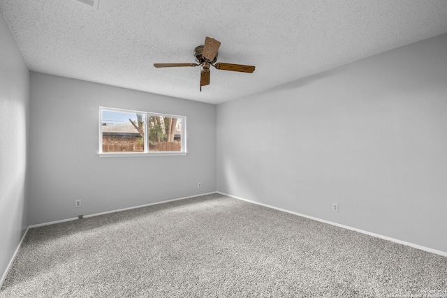 carpeted spare room featuring ceiling fan and a textured ceiling