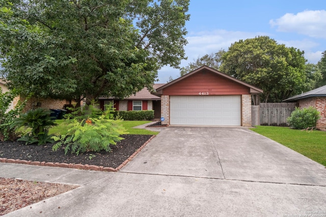 view of front of house featuring a front yard and a garage