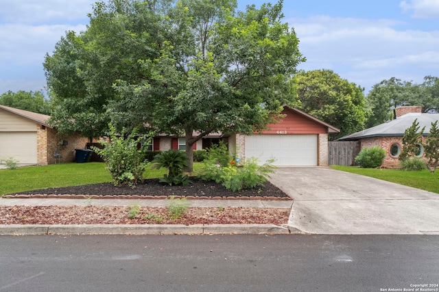 view of front of house with a front lawn and a garage