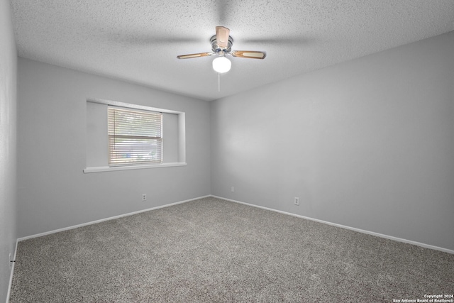 carpeted empty room featuring a textured ceiling and ceiling fan