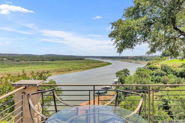 balcony with a rural view and a water view