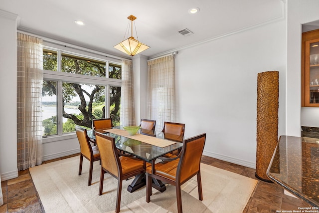 dining room featuring ornamental molding and a wealth of natural light