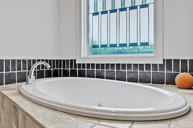 bathroom with a relaxing tiled tub