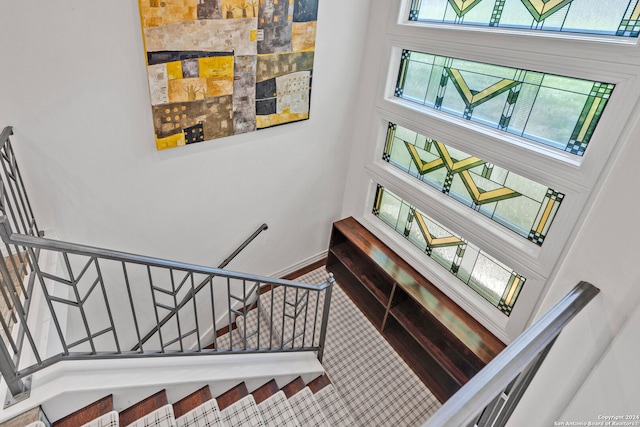 stairs featuring a towering ceiling