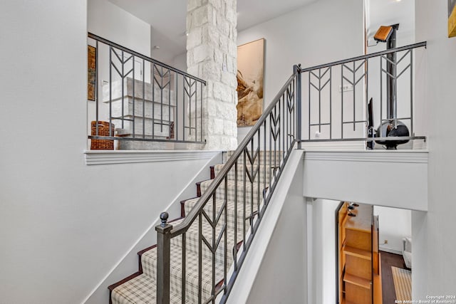 staircase featuring ornate columns