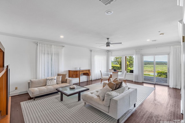 living room featuring dark hardwood / wood-style flooring, ceiling fan, and crown molding