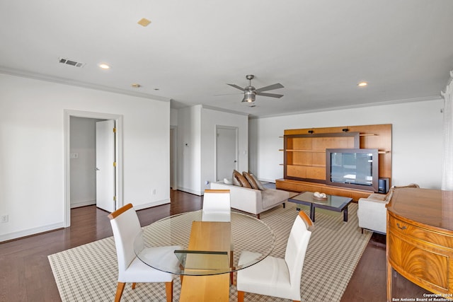 dining space featuring ceiling fan, dark hardwood / wood-style floors, and ornamental molding