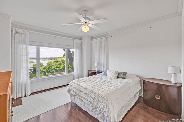 bedroom featuring ceiling fan, ornamental molding, and dark parquet floors