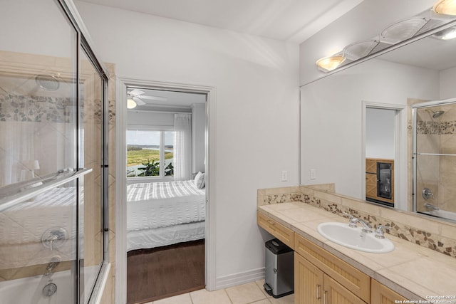 bathroom featuring ceiling fan, tile patterned flooring, vanity, and combined bath / shower with glass door