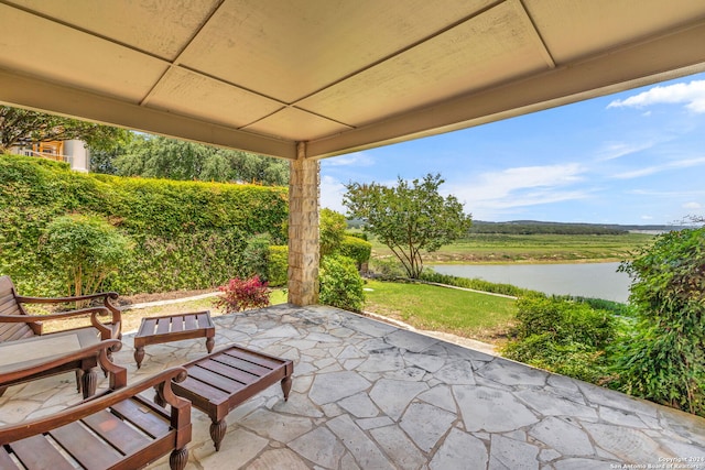 view of patio with a water view