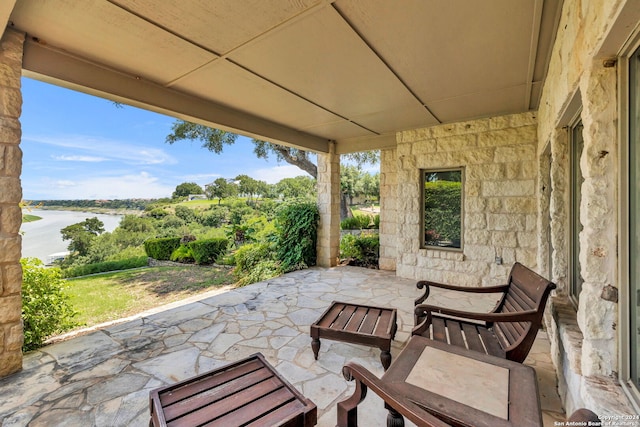 view of patio with a water view