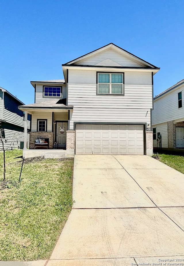 view of front of house featuring a garage and a front yard