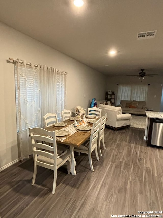 dining area with hardwood / wood-style flooring and ceiling fan