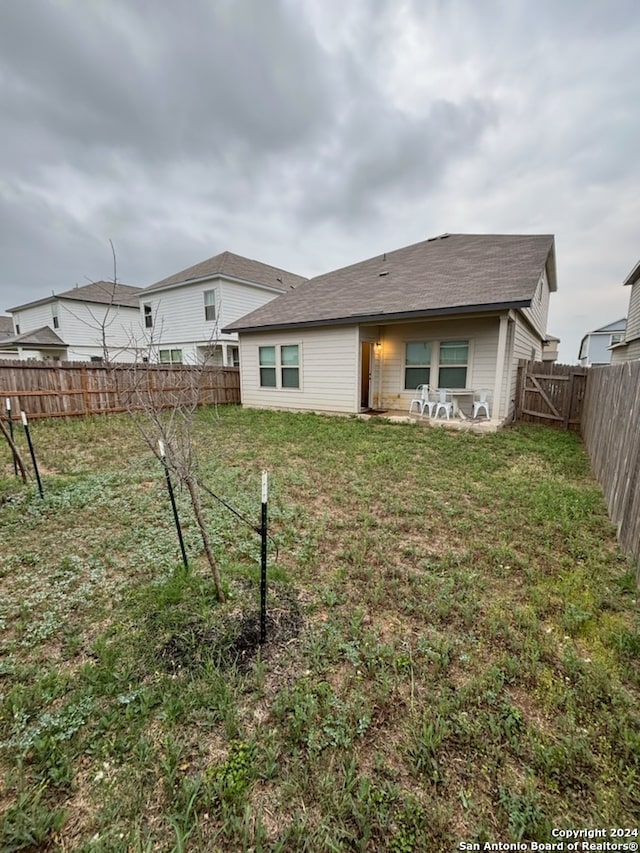 rear view of house featuring a lawn