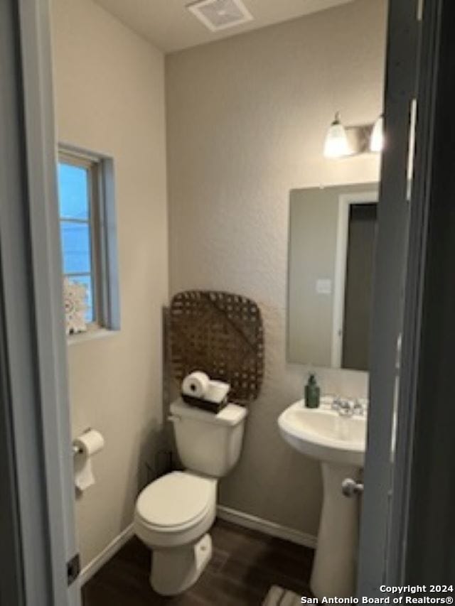 bathroom with wood-type flooring and toilet