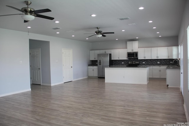 kitchen featuring white cabinetry, stainless steel appliances, and light hardwood / wood-style flooring