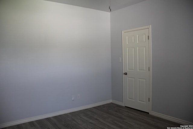 empty room featuring dark hardwood / wood-style flooring