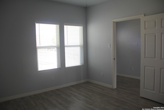 unfurnished room featuring dark hardwood / wood-style floors