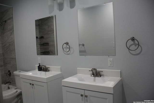 full bathroom featuring vanity, bathing tub / shower combination, and toilet