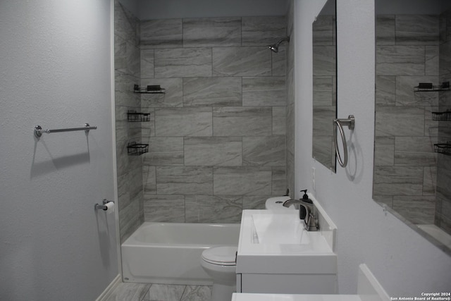 full bathroom featuring vanity, toilet, and tiled shower / bath combo