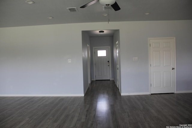 unfurnished room with ceiling fan and dark wood-type flooring