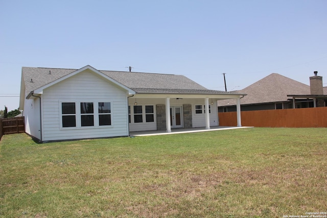 back of house with a patio, ceiling fan, and a lawn