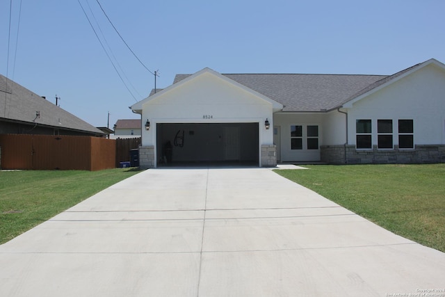 view of front of property with a garage and a front lawn