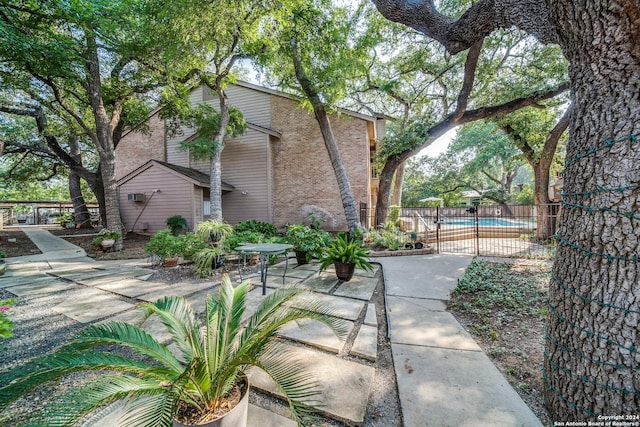 view of home's exterior featuring a patio area and a fenced in pool