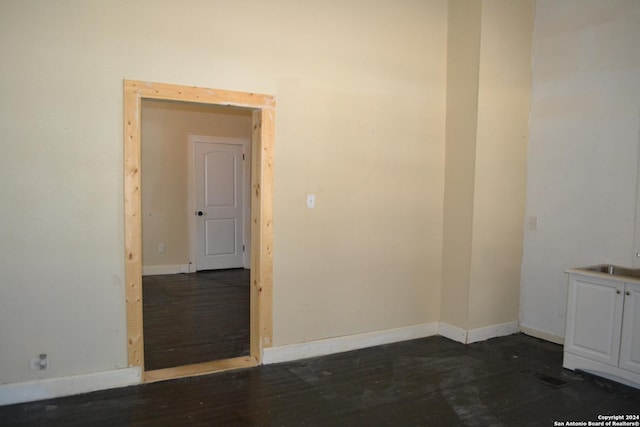 unfurnished room with dark hardwood / wood-style floors