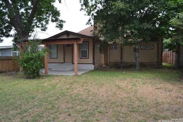 rear view of house with a yard