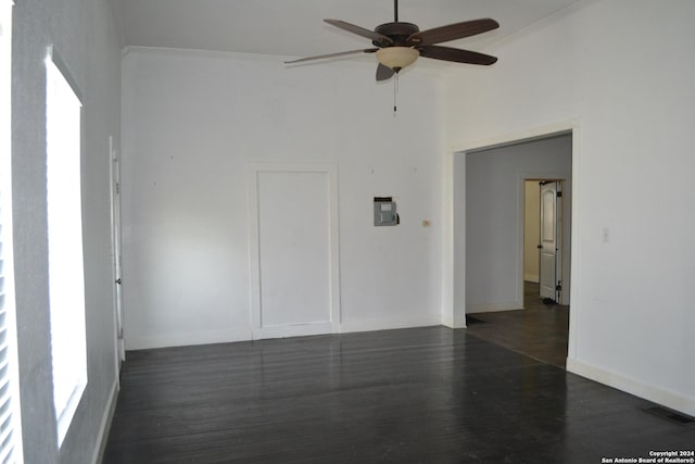 unfurnished room with dark hardwood / wood-style floors, ceiling fan, and ornamental molding