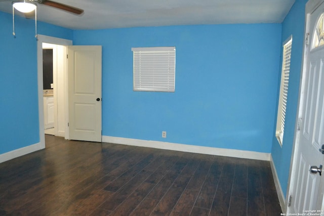 unfurnished bedroom with dark hardwood / wood-style flooring and ceiling fan