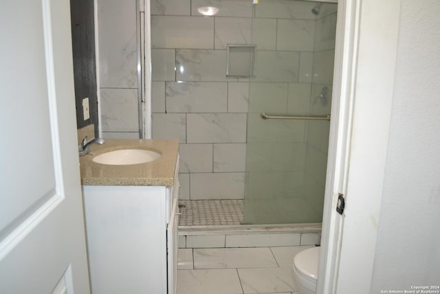 bathroom with vanity, an enclosed shower, and toilet