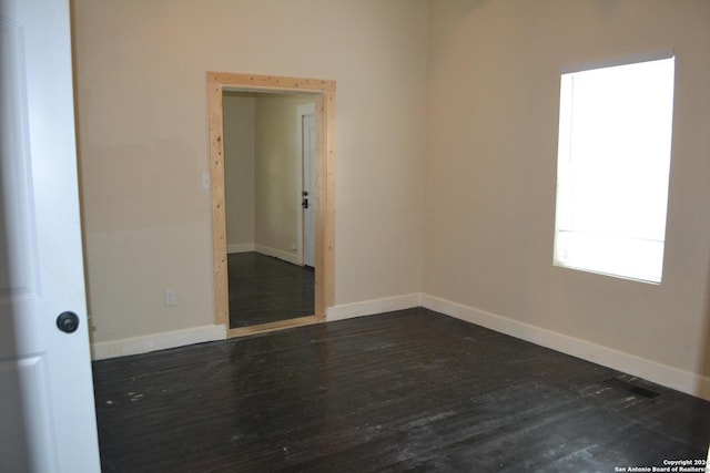 unfurnished room with dark hardwood / wood-style floors