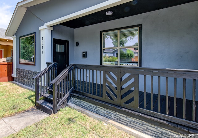 view of exterior entry with a yard