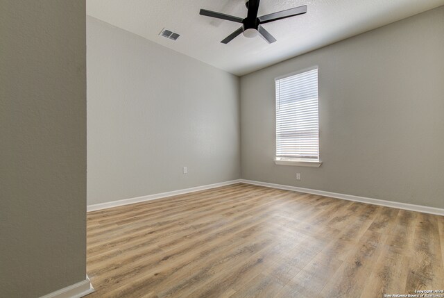 unfurnished room with ceiling fan and light hardwood / wood-style flooring