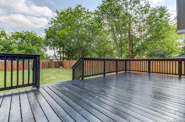 wooden deck featuring a yard