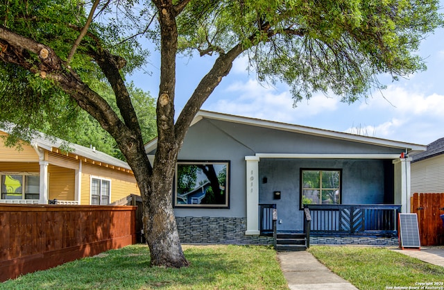 view of front of house with a porch and a front lawn