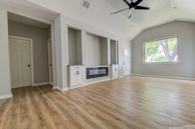 unfurnished living room with a textured ceiling, lofted ceiling, ceiling fan, and hardwood / wood-style floors