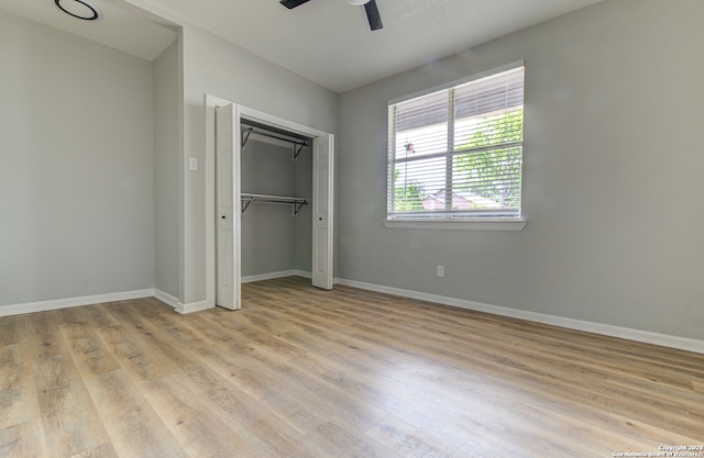 unfurnished bedroom with a closet, ceiling fan, and light hardwood / wood-style flooring