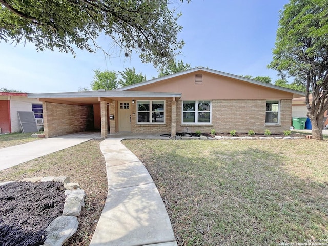 single story home with a front lawn and a carport