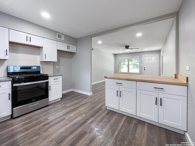 kitchen featuring butcher block countertops, white cabinetry, and stainless steel range oven