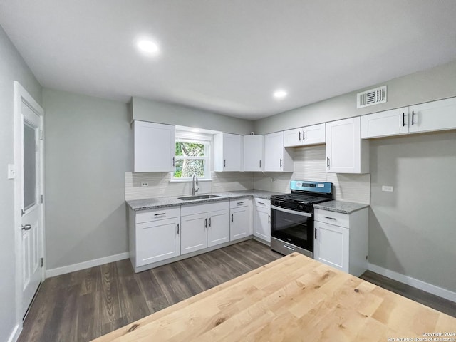 kitchen featuring white cabinets, tasteful backsplash, sink, and stainless steel range with gas stovetop