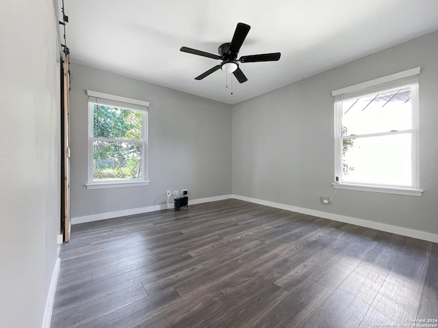 unfurnished room featuring ceiling fan and dark wood-type flooring