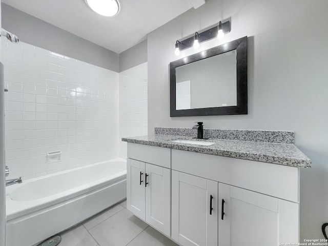 bathroom with tile patterned flooring, vanity, and  shower combination