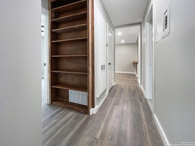 hallway with dark hardwood / wood-style flooring