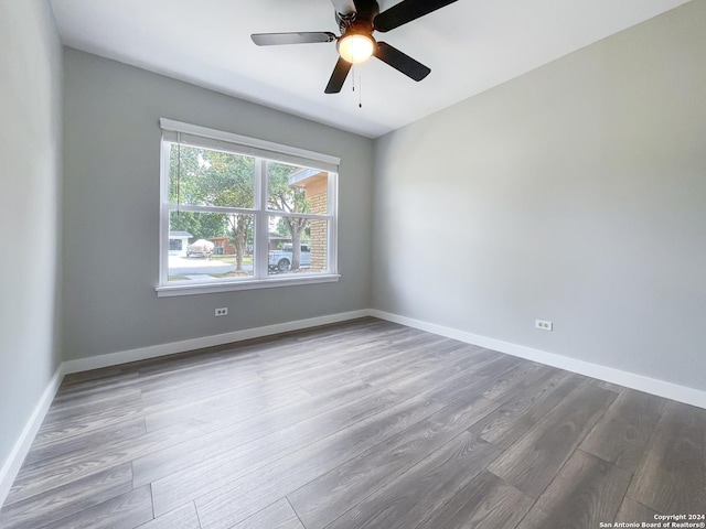 empty room featuring ceiling fan and hardwood / wood-style floors