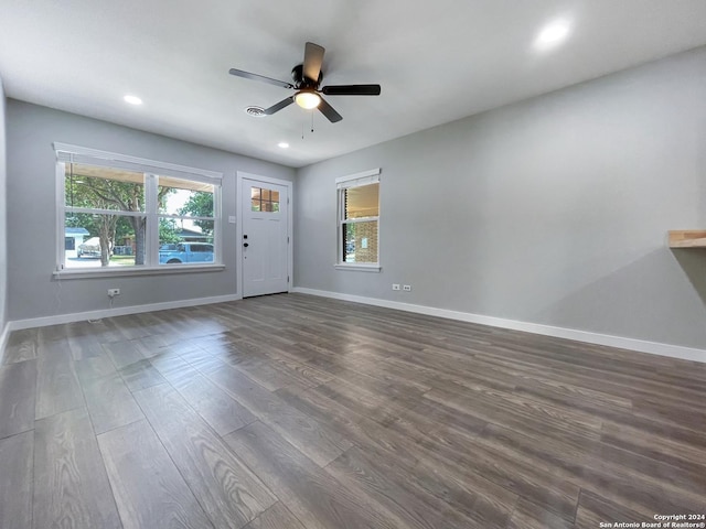 interior space with dark hardwood / wood-style floors and ceiling fan